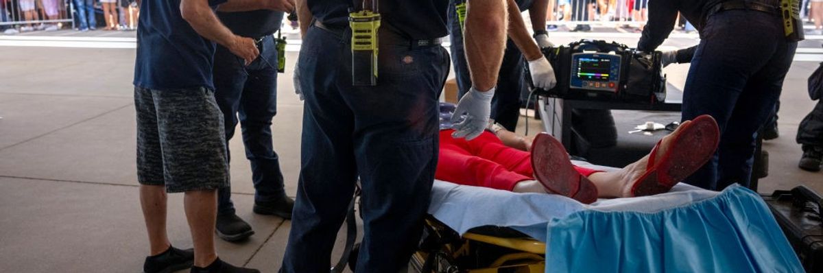 A woman is tended to for heat exhaustion as the temperature reaches 108ºF in Phoenix