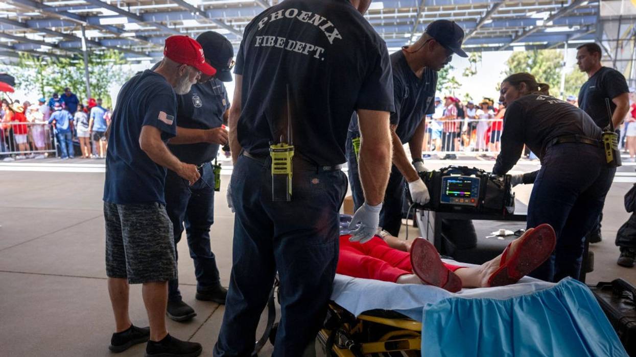 A woman is tended to for heat exhaustion as the temperature reaches 108ºF in Phoenix