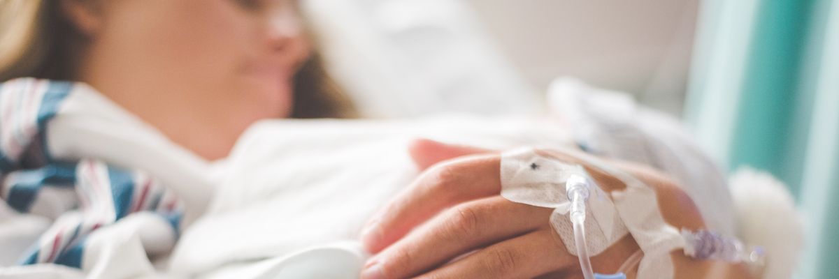 A woman lays in a hospital bed