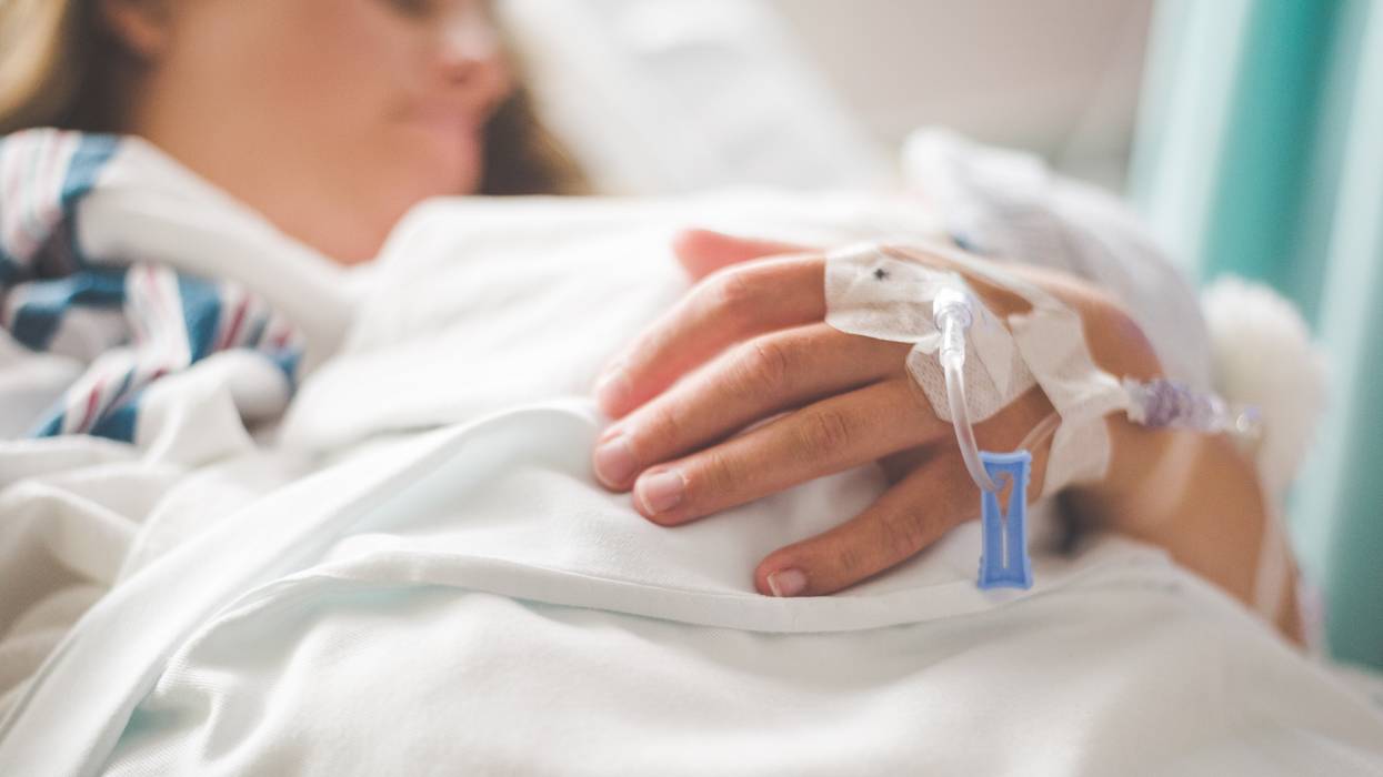 A woman lays in a hospital bed
