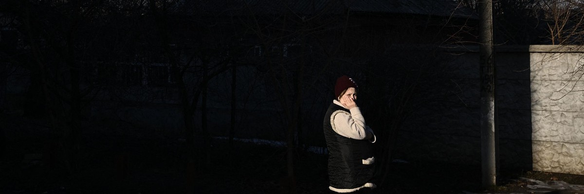 A woman looks on as Russia launches its attack on Ukraine