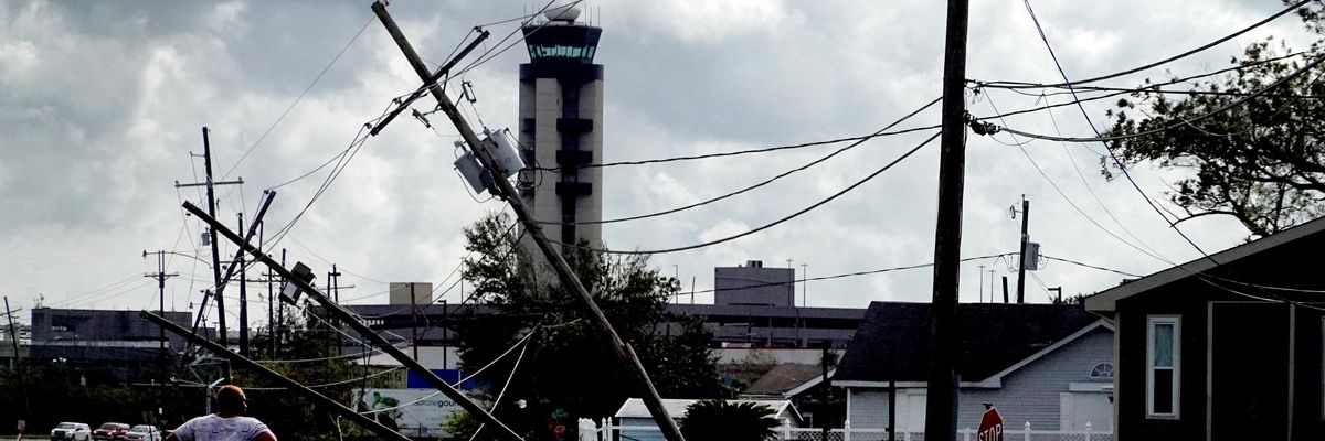 A woman looks over damage to a neighborhood caused by Hurricane Ida on August 30, 2021 in Kenner, Louisiana.