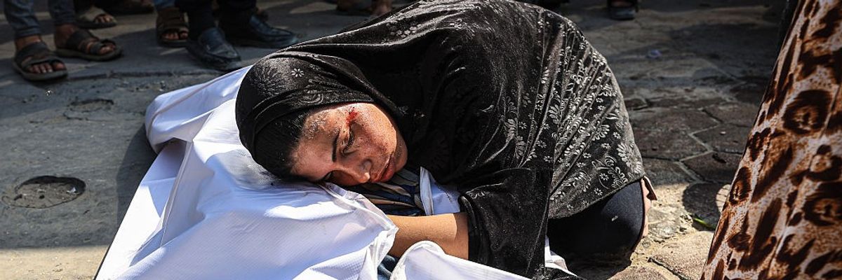 A woman mourns a dead body in Gaza.
