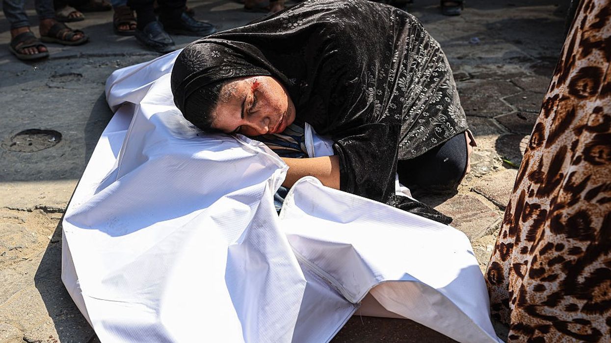 A woman mourns a dead body in Gaza.