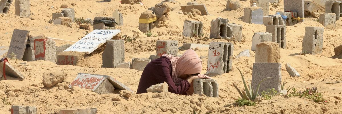 A woman mourns at a grave in Gaza.
