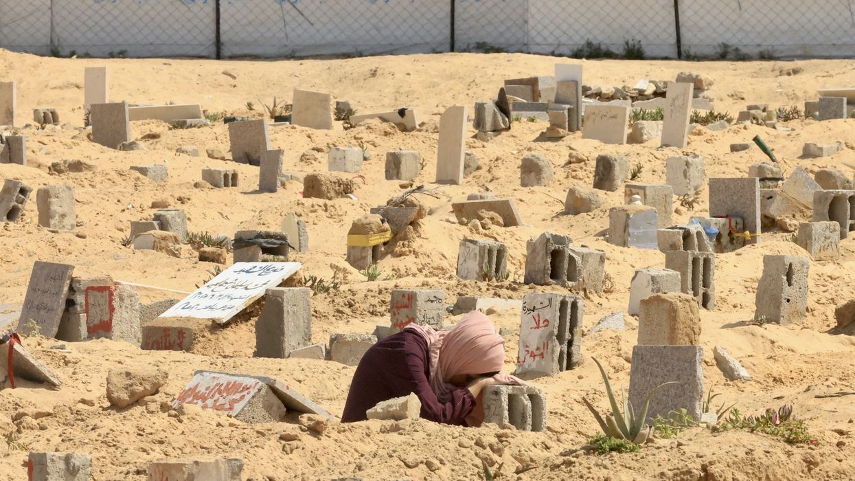 A woman mourns at a grave in Gaza.