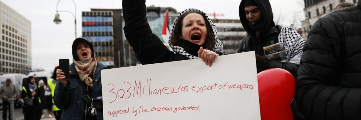 A woman protests the German government's arms exports to Israel