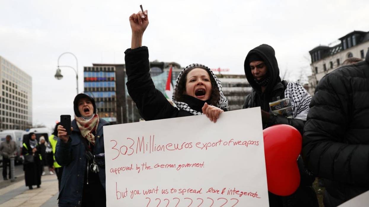 A woman protests the German government's arms exports to Israel