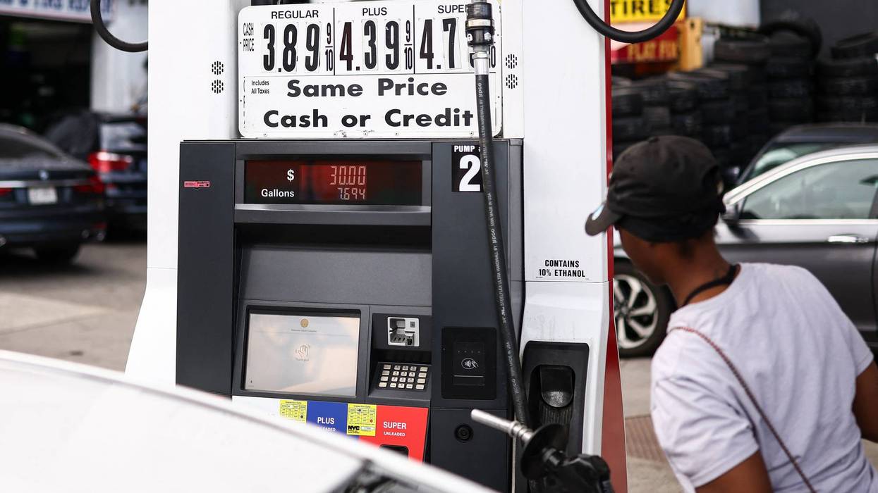 a woman pumping gas