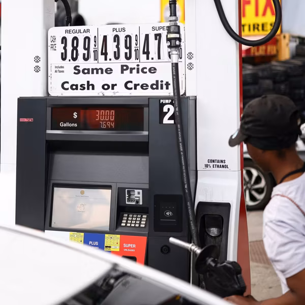 a woman pumping gas