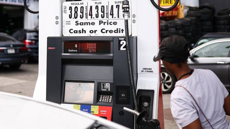 a woman pumping gas