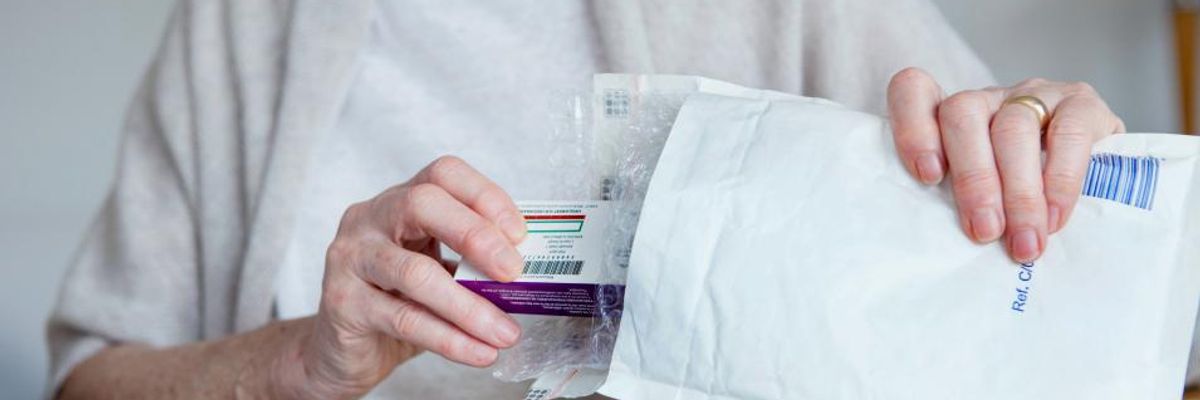 A woman receives mail-order prescription medicine.