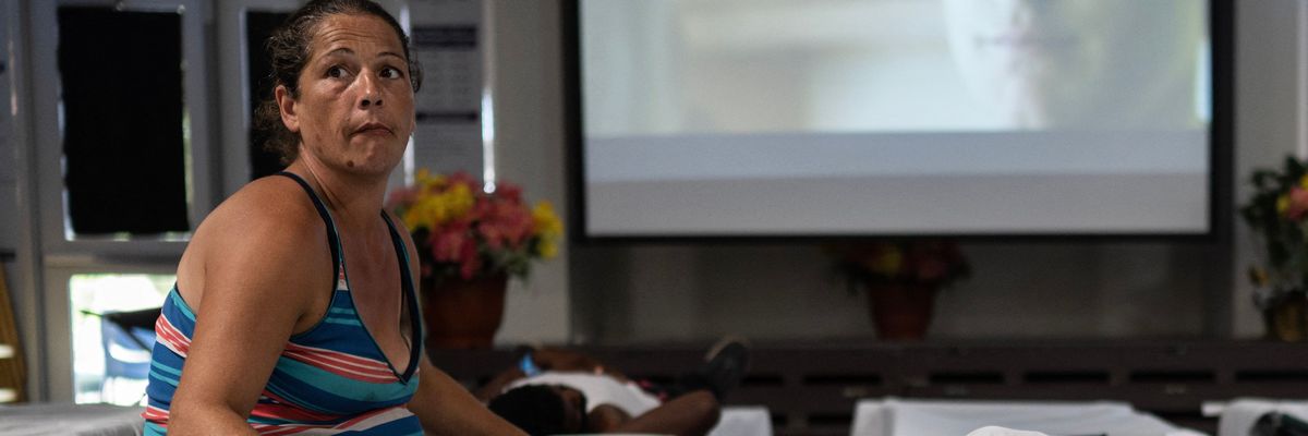 A woman rests on a cot at a Salvation Army