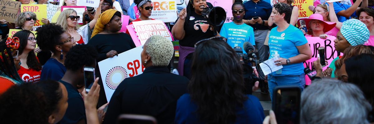 A woman speaks during a protest against recently passed abortion ban bills at the Georgia State Capitol building, on May 21, 2019 in Atlanta, Georgia.