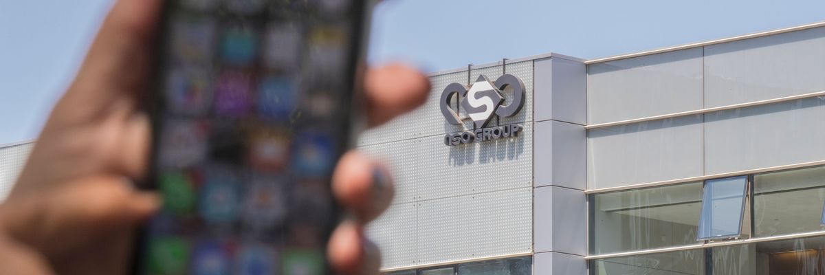 A woman uses an iPhone in front of the building of the NSO Group, developer of the spyware Pegasus, on August 28, 2016, in Herzliya, Israel.