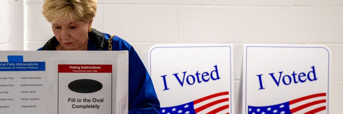 A woman votes on the first day of Virginia's in-person early voting