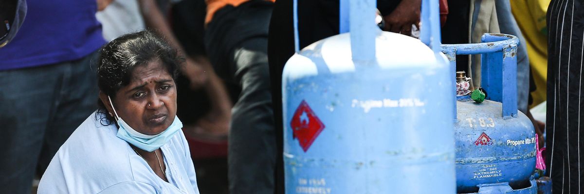 A woman waits to buy fuel in Sri Lanka's capital