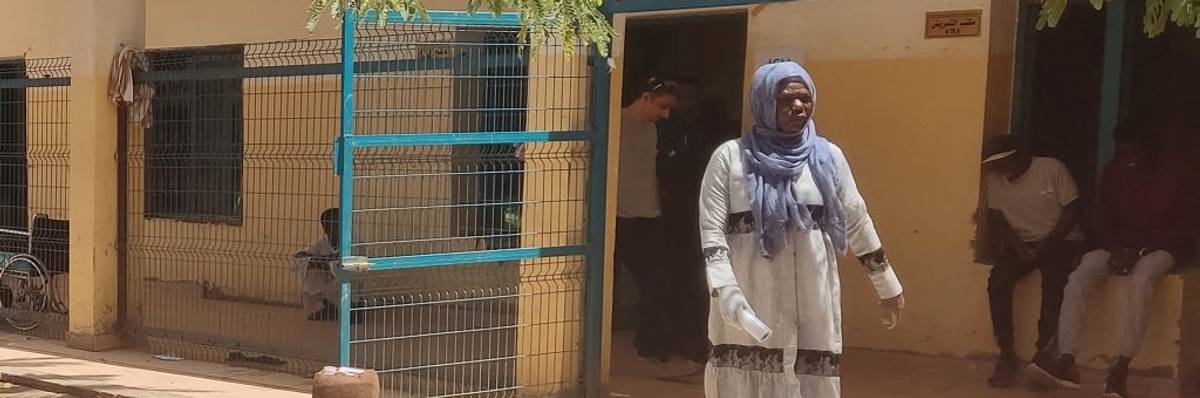 A woman walks in a Sudan hospital.