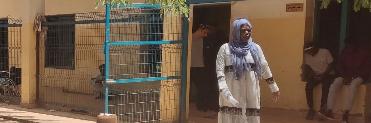 A woman walks in a Sudan hospital.