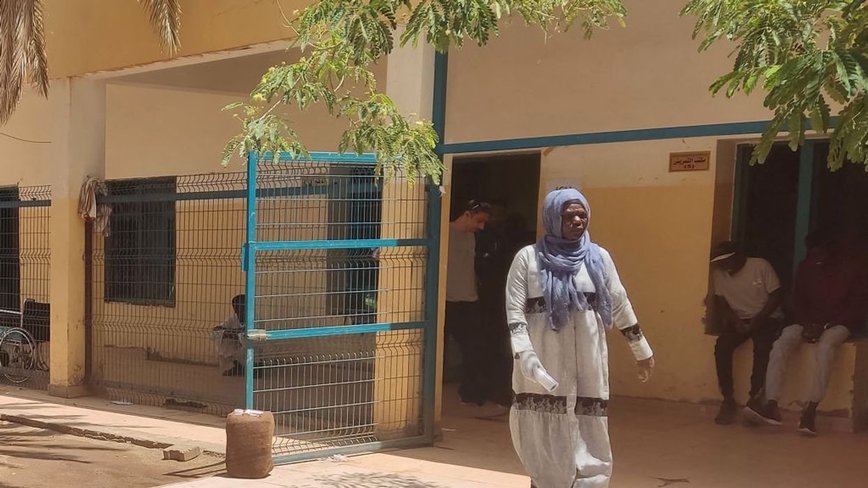 A woman walks in a Sudan hospital.