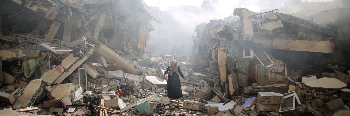 A woman walks through the ruins of Gaza