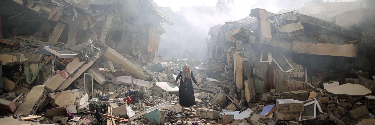 A woman walks through the ruins of Gaza 