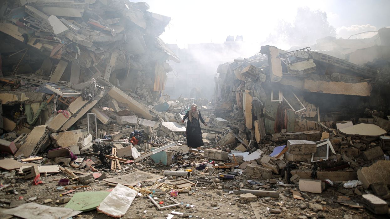 A woman walks through the ruins of Gaza