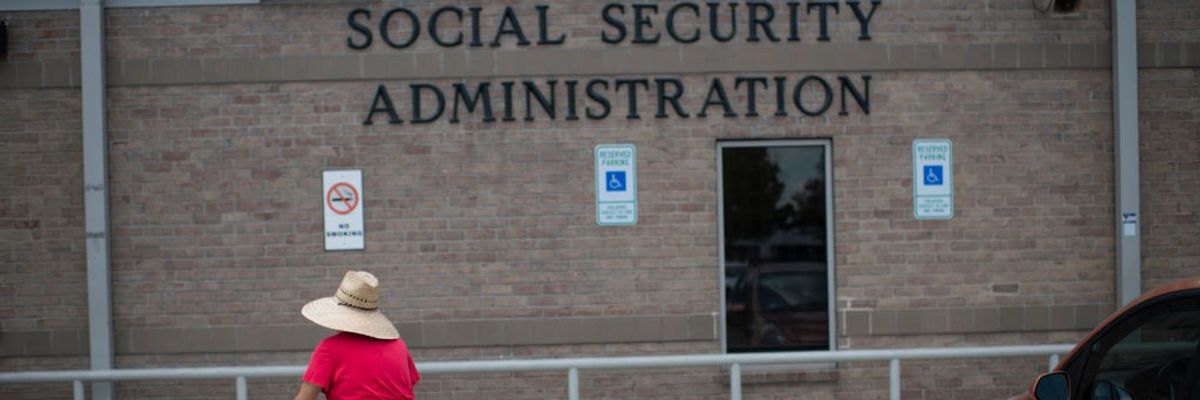 A woman walks toward a Social Security office.