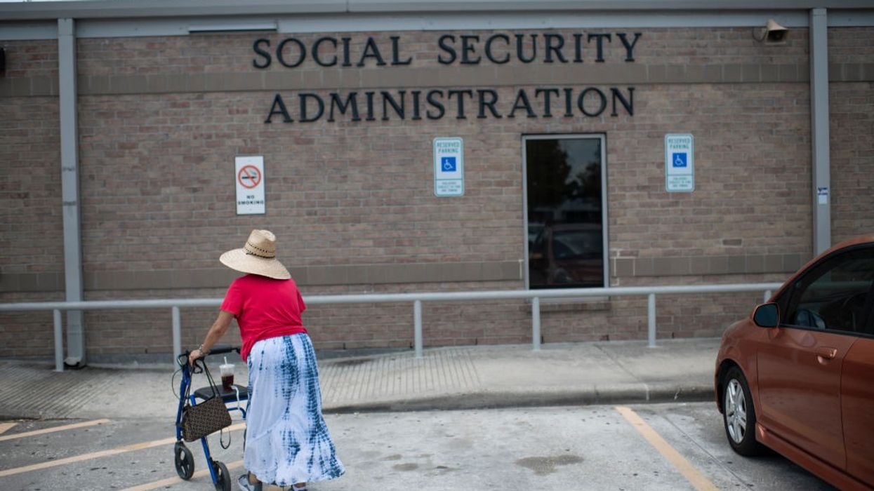 A woman walks toward a Social Security office.
