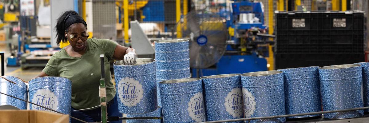 A woman works at a can company.