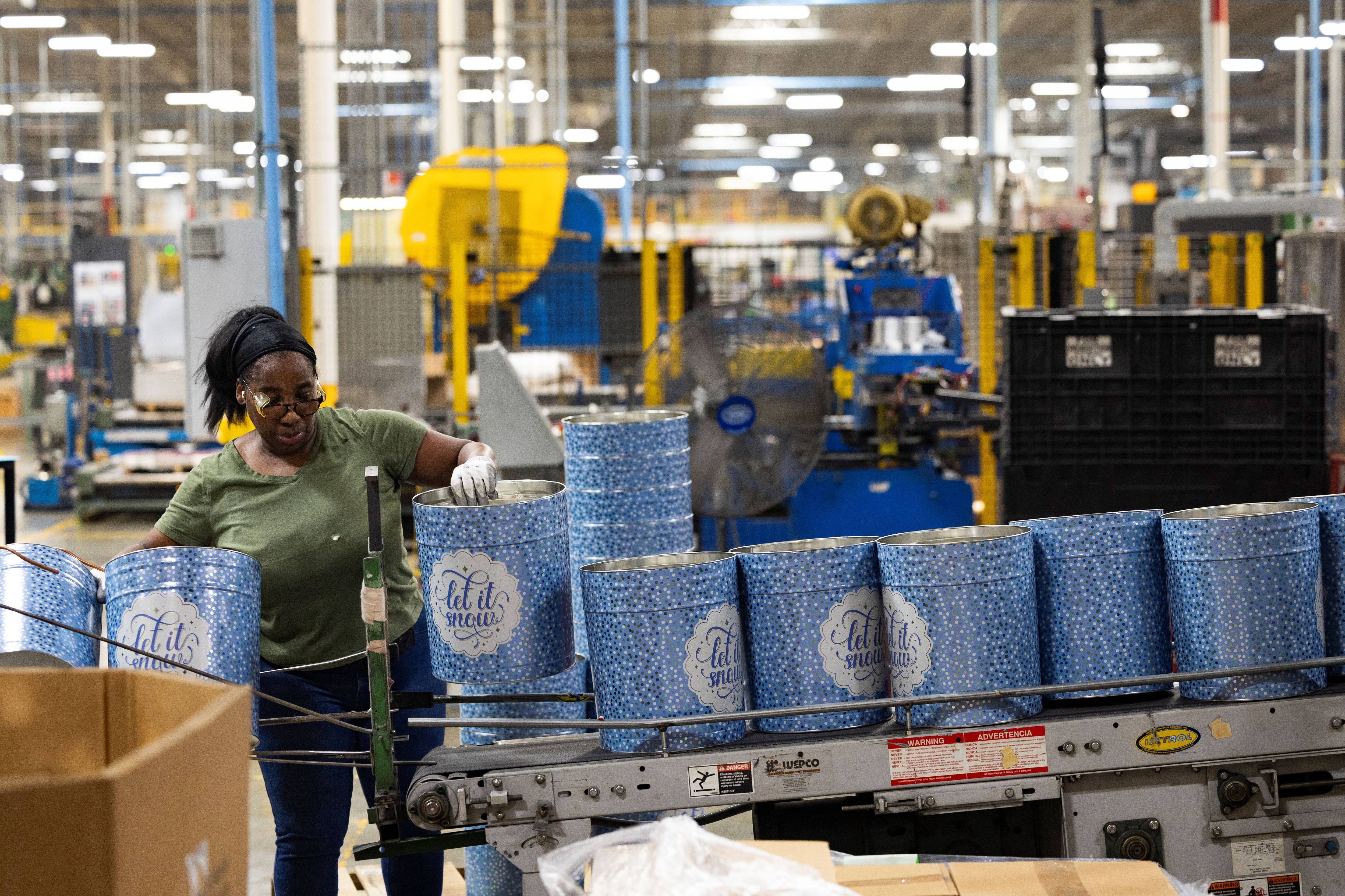 A woman works at a can company.