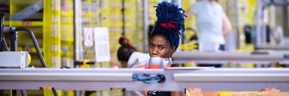 A woman works at a distrubiton station at the 855,000-square-foot Amazon fulfillment center in Staten Island, one of the five boroughs of New York City, on February 5, 2019.