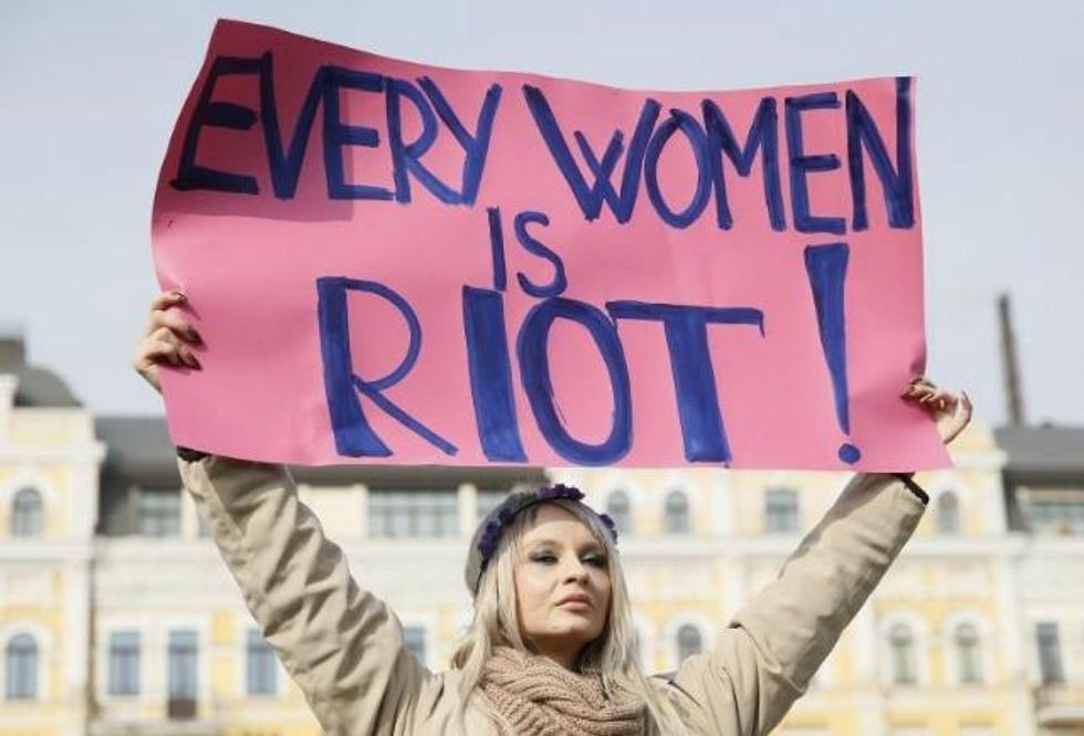A women holds up a sign at a rally in Kiev, Ukraine. (Photo: Reuters)