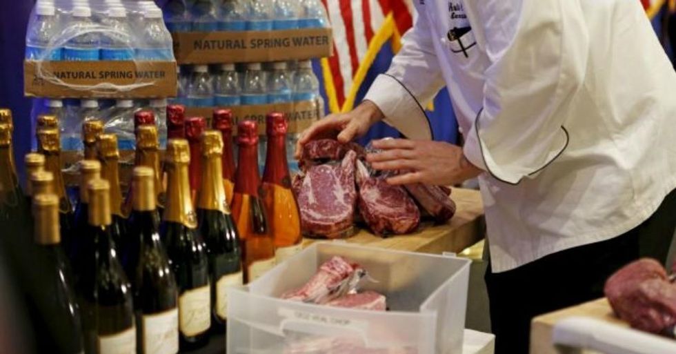 A worker arranges meat described as 'Trump meat' near the podium at the Trump National Golf Club in Jupiter, Florida. (Photo: Reuters/Joe Skipper)