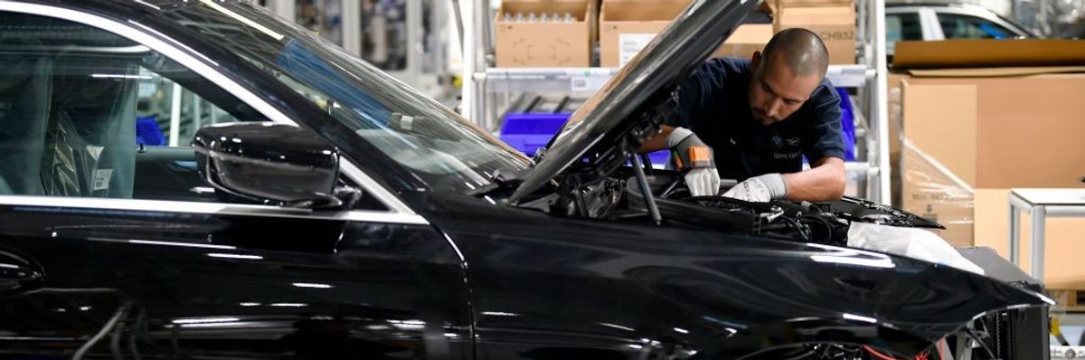 A worker assembles a BMW in a Mexican factory