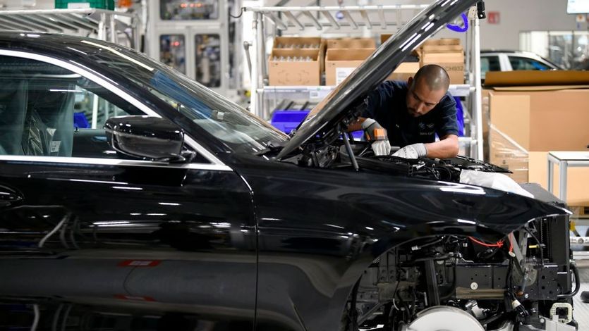 A worker assembles a BMW in a Mexican factory