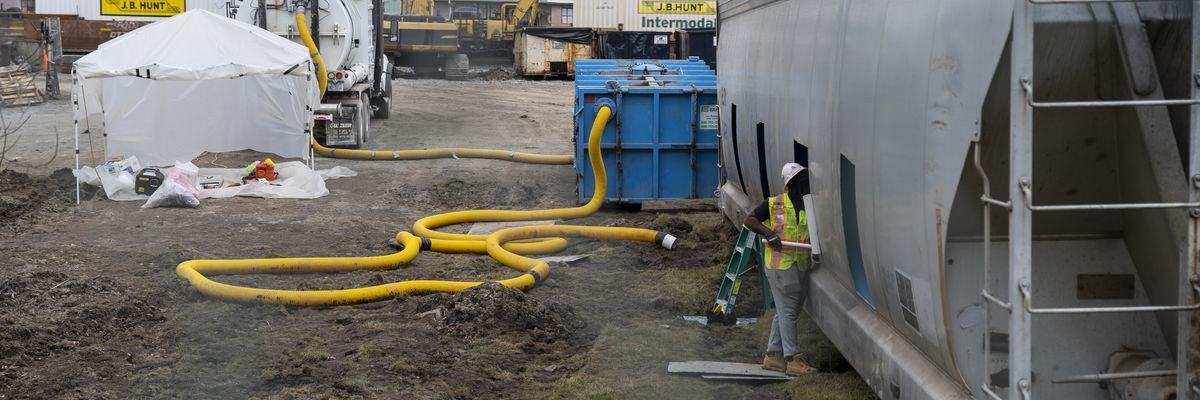 A worker cleans the inside of a derailed train car in East Palestine, Ohio on February 16, 2023.