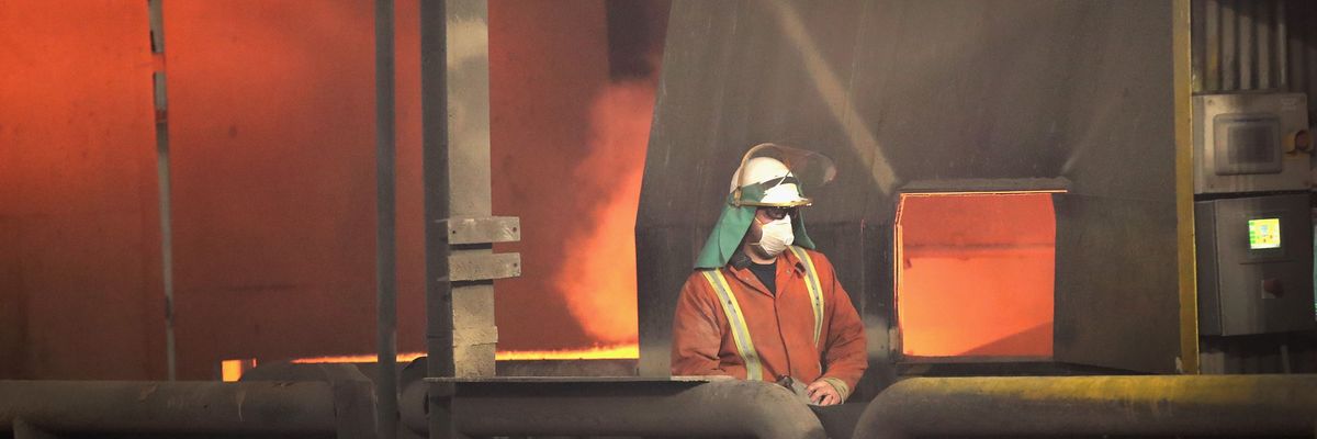 A worker monitors operations as steel is melted at 3,000°F in an electric arc furnace at the NLMK Indiana steel mill on March 15, 2018 in Portage, Indiana.
