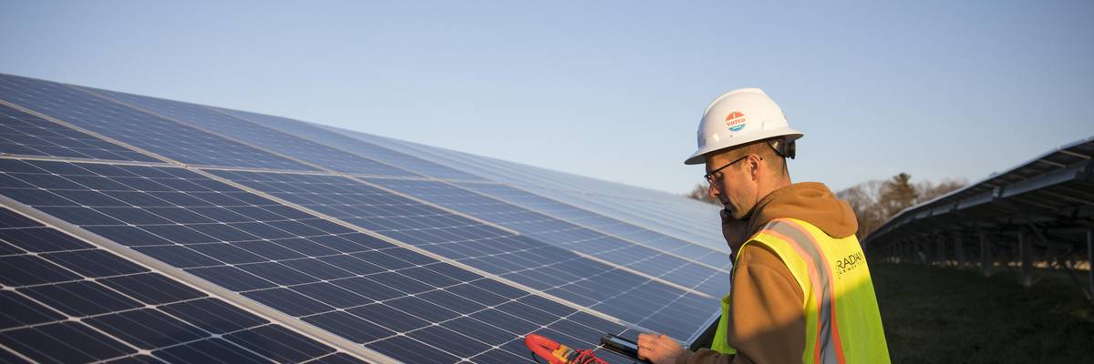 A worker performs maintenance at the BlueWave Community Solar Farm in Grafton, Massachusetts on December 4, 2017. (Photo: Robert Nickelsberg/Getty Images)