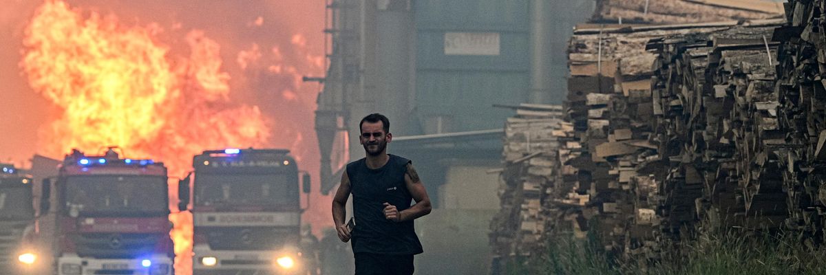 A worker runs from a forest fire in Portugal