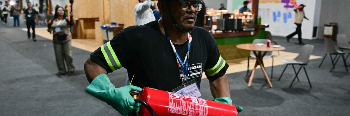 A worker runs to put out COP fire.