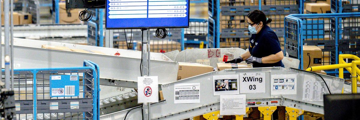 A worker sorts parcels in the outbound dock at Amazon fulfillment center