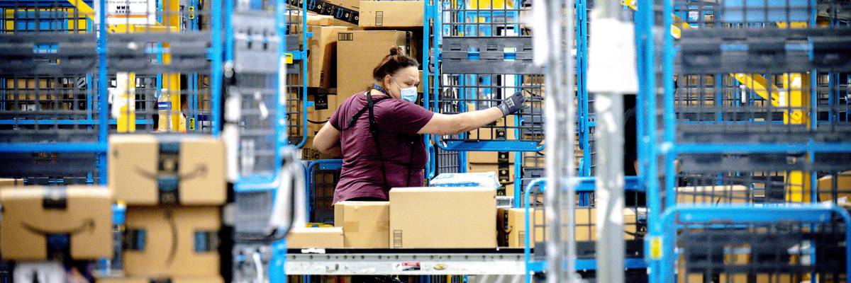 A worker sorts parcels in the outbound dock at an Amazon fulfillment center