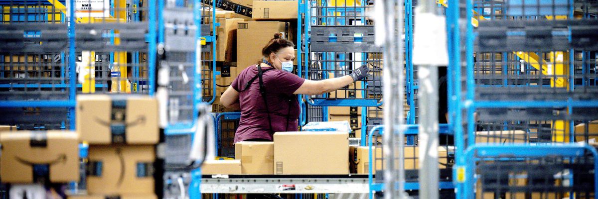 A worker sorts parcels in the outbound dock at an Amazon fulfillment center