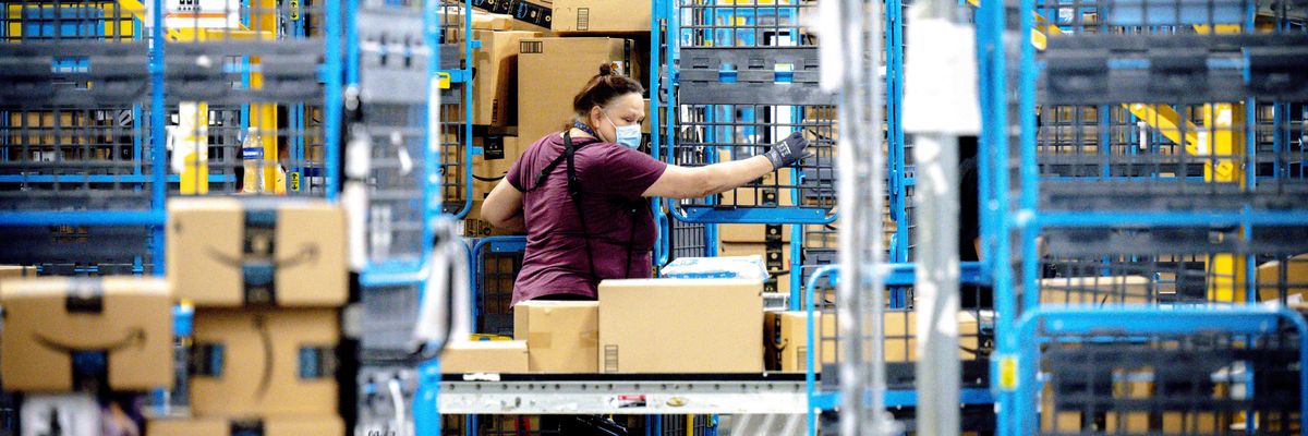 A worker sorts parcels in the outbound dock at an Amazon fulfillment center