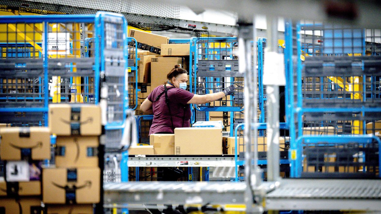 A worker sorts parcels in the outbound dock at an Amazon fulfillment center