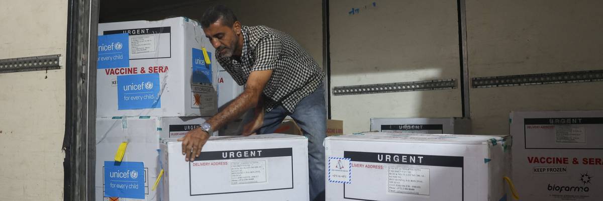 A worker unloads a shipment of polio vaccines