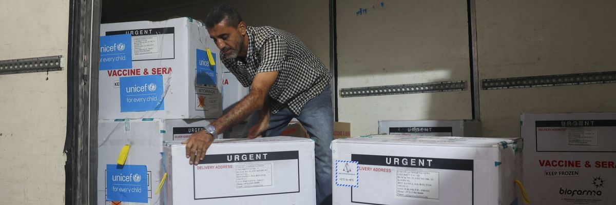 A worker unloads a shipment of polio vaccines