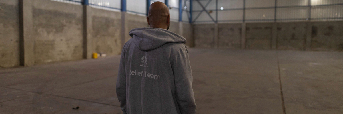 A World Central Kitchen staffer stands in an empty warehouse in Gaza