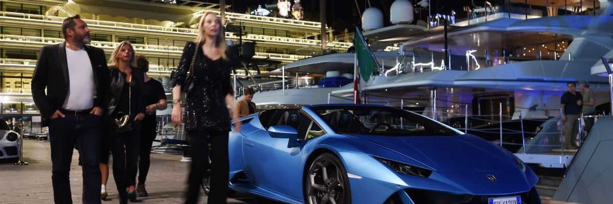 A yacht party in Monaco with a Lamboghini parked by vessels